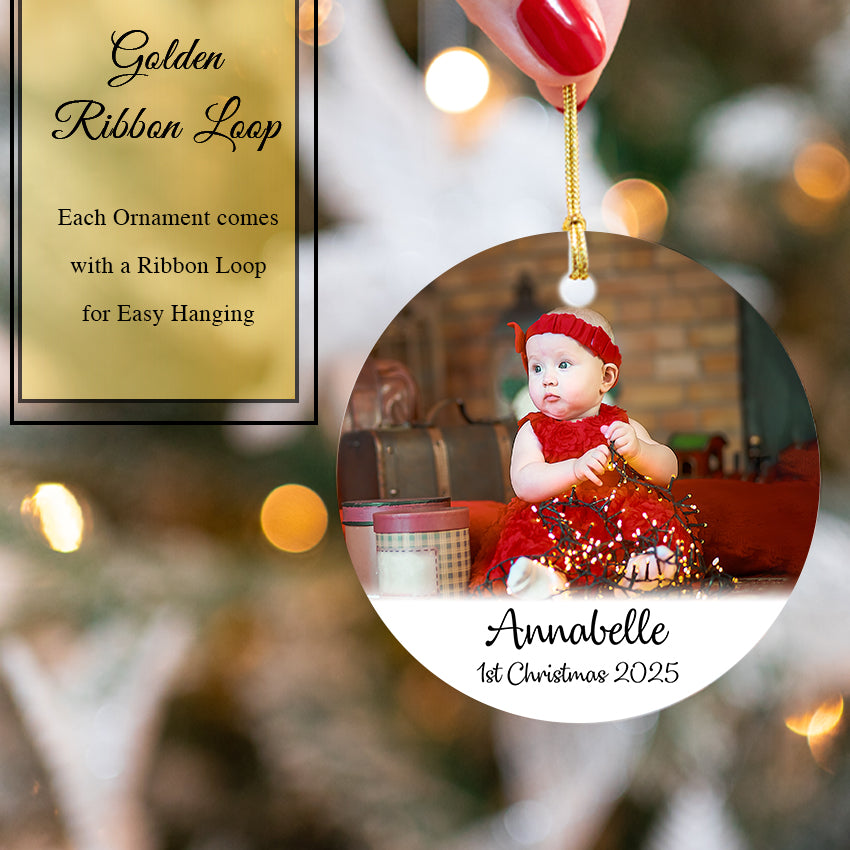 Personalized Christmas ornament with a baby's photo and 'Annabelle 1st Christmas 2025' text, Golden Ribbon Loop included.