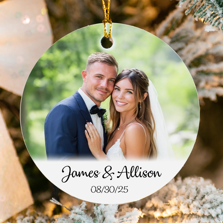Personalized Christmas ornament with a couple's photo and names against a festive background.