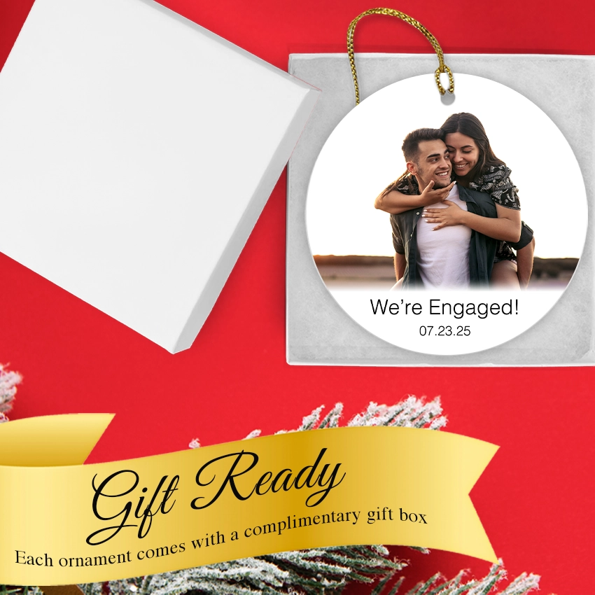 Personalized photo ornament with 'We're Engaged!' text on a red background. Gift Box included.