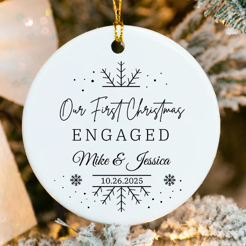 Engagement announcement ornament with ribbon banner reading We’re Engaged and custom names & date