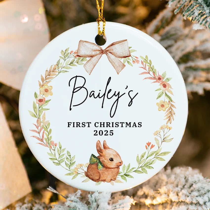 Decorative ornament for 'Bailey's First Christmas 2025' with a bunny and floral wreath on a white background.