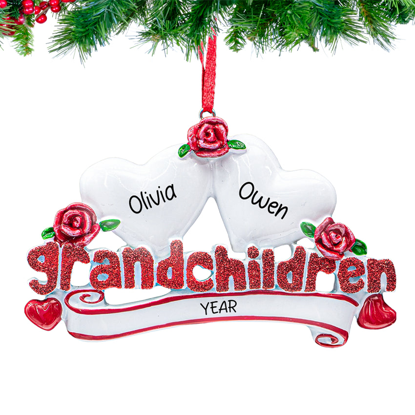Ornament reading “Grandchildren” with two heart charms personalized with children’s names and 2025 on a snowy Christmas tree branch
