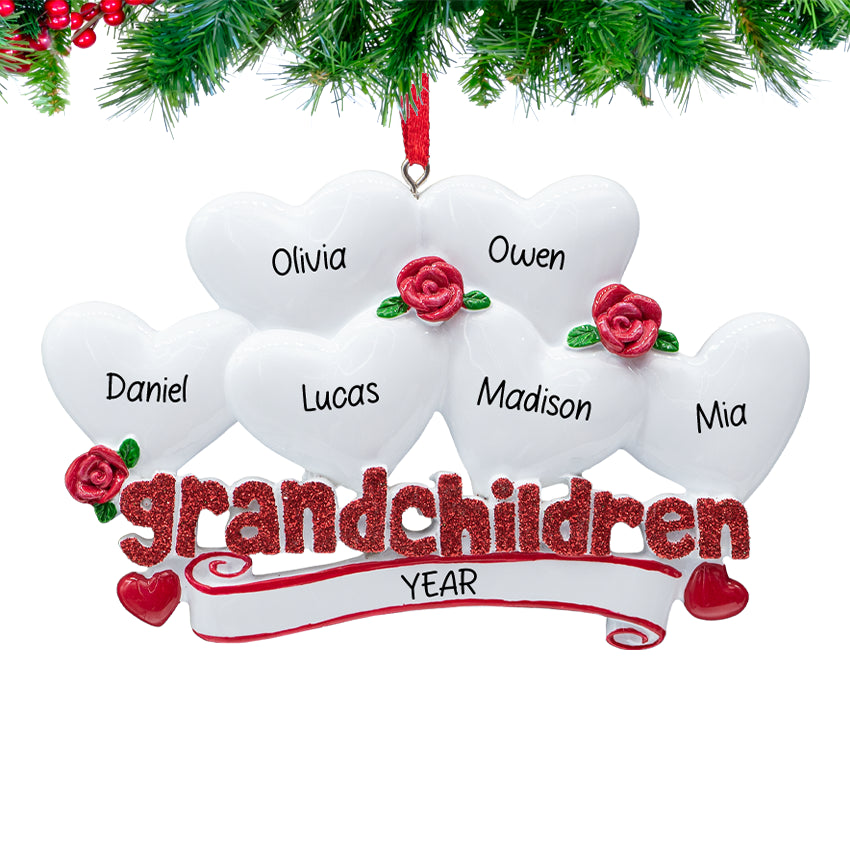 "Grandchildren” ornament with six heart charms personalized with names and 2025, hanging on a snowy Christmas tree branch.