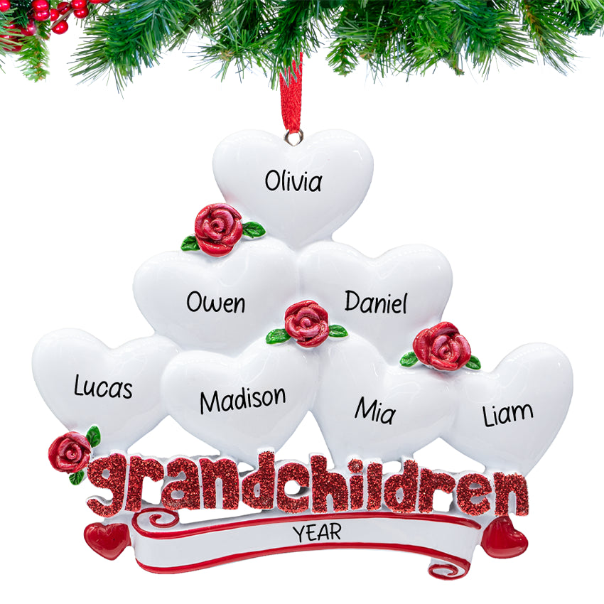 Grandchildren” ornament with seven heart charms personalized with names and 2025, hanging on a snowy Christmas tree branch.