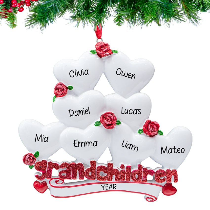 Grandchildren” ornament with eight heart charms personalized with names and 2025, hanging on a snowy Christmas tree branch