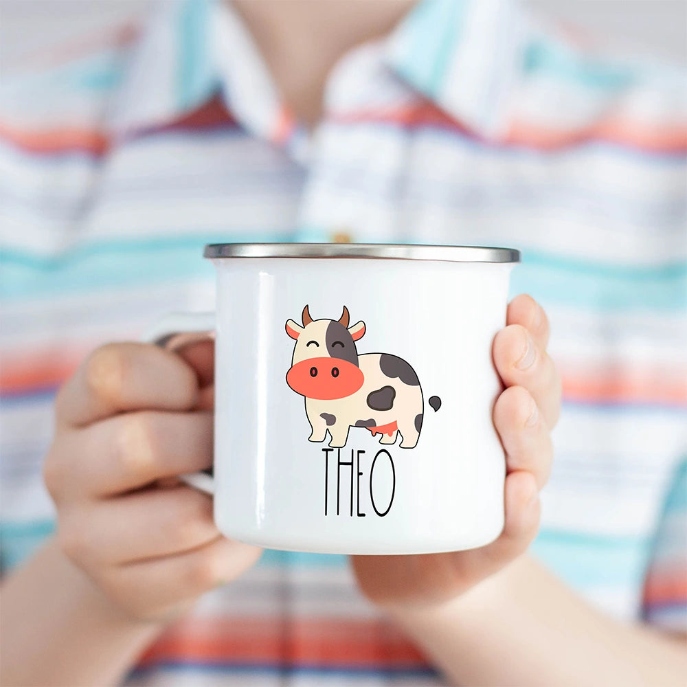 Personalized cow hot chocolate kids mug held in a child’s hand