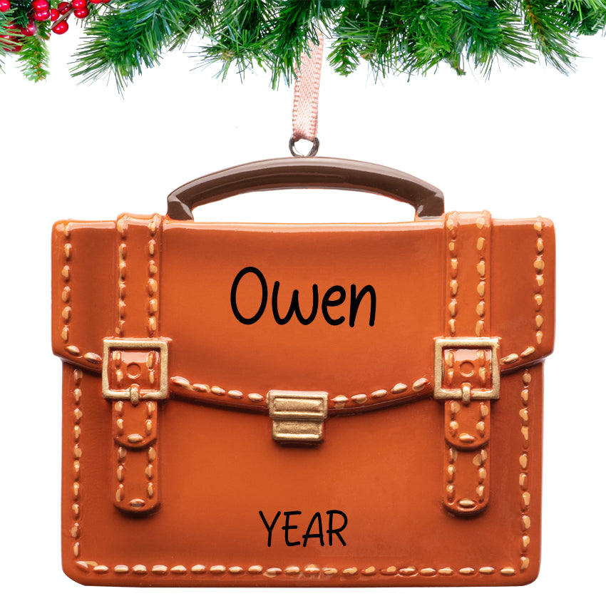 Personalized briefcase Christmas ornament with gold clasps and hand‑lettered name