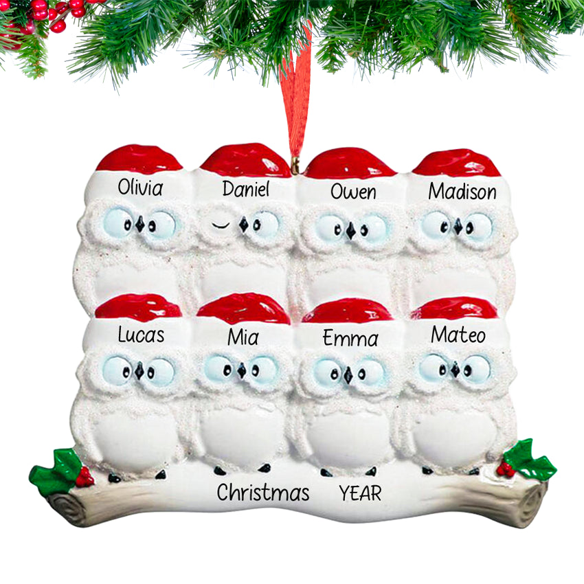 owl parents with six owlets on a snowy branch, ornament personalized with eight names and 2025, hanging on a festive Christmas tree.