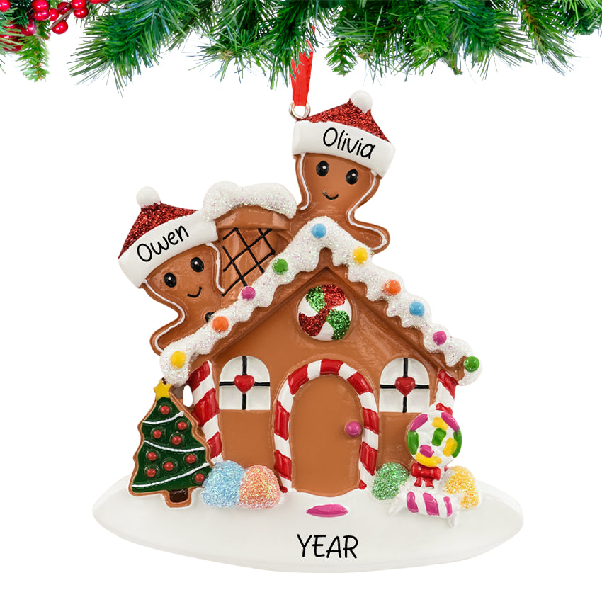 Gingerbread house ornament with a smiling couple, personalized with names and 2025, hanging on a festive Christmas tree branch.