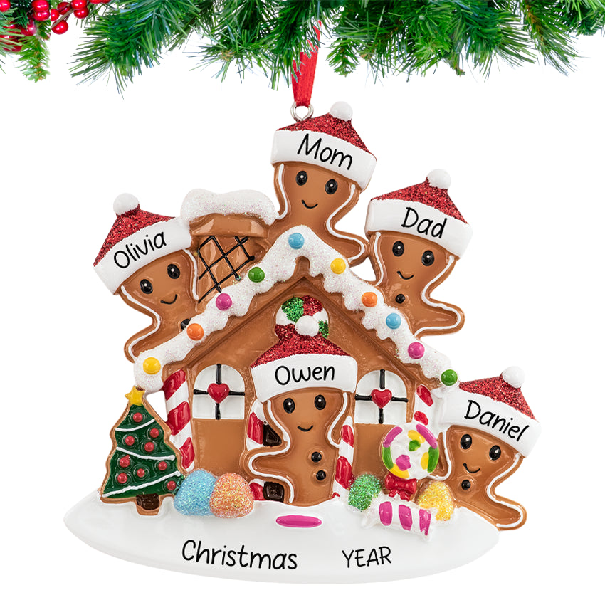 Gingerbread house ornament with a smiling family, personalized with names and 2025, hanging on a festive Christmas tree branch.