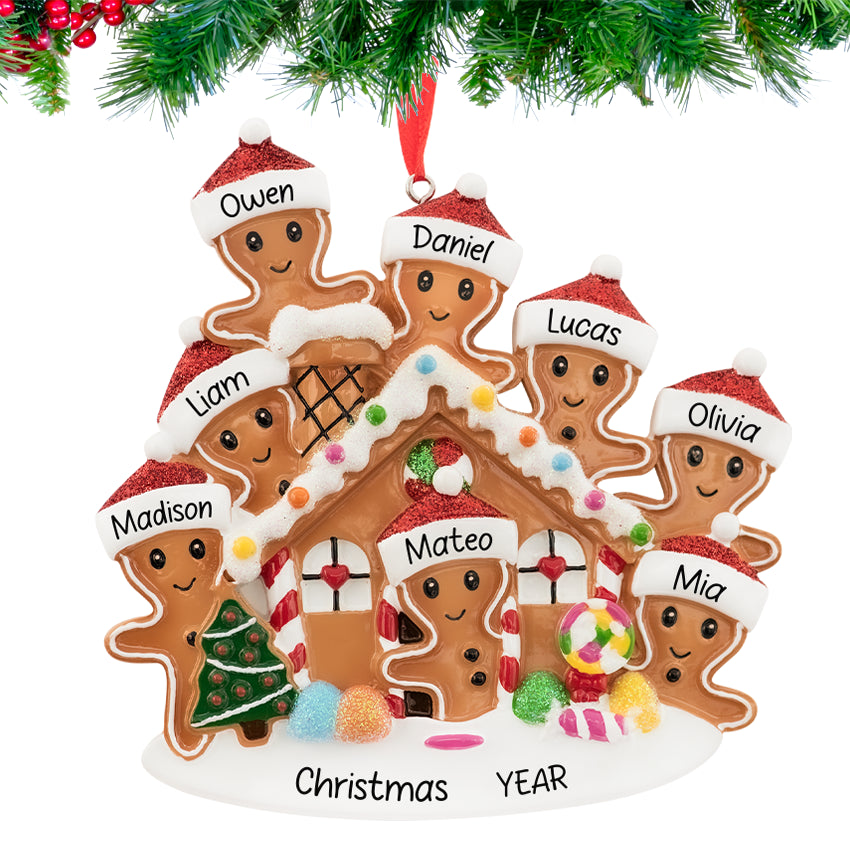 Gingerbread house ornament with a smiling family, personalized with names and 2025, hanging on a festive Christmas tree branch.