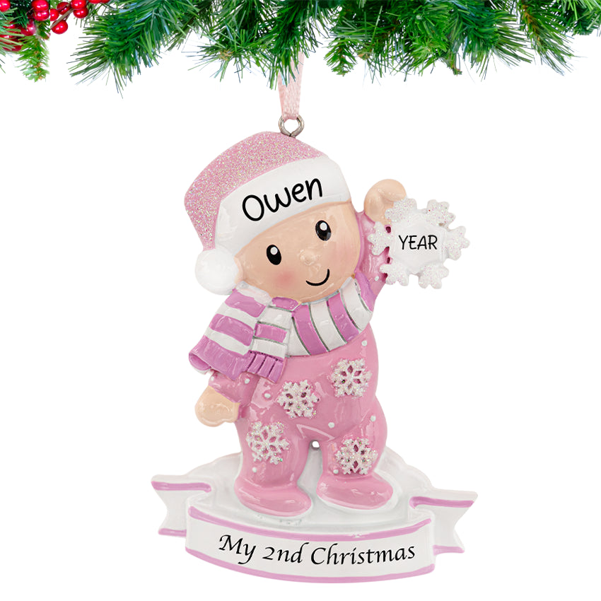 Personalized baby's second Christmas ornament with a girl holding a snowflake, a sweet keepsake for baby girl