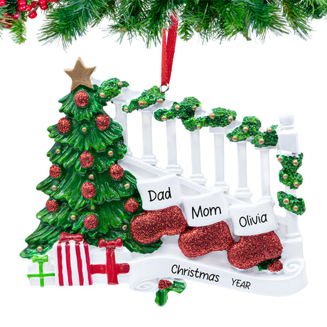 Three personalized resin stockings labeled with names and “2025,” hanging on a festive garland.