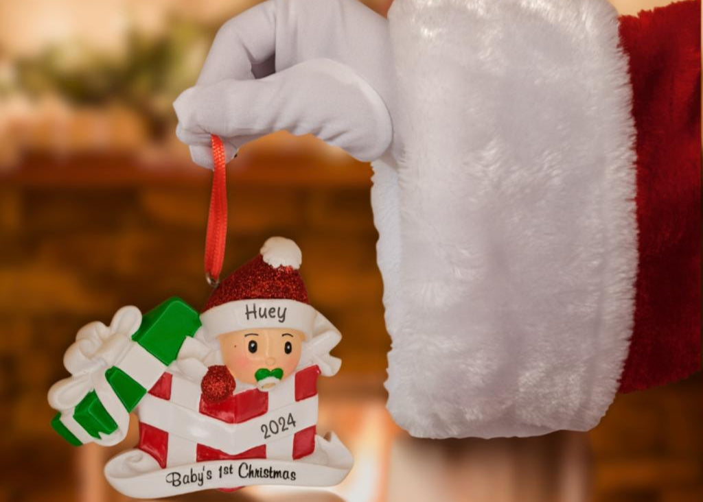 Baby 1st xmas ornament on santa hand