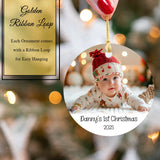 Personalized Christmas photo ornament with a baby's first Christmas text, featuring a gold ribbon loop.