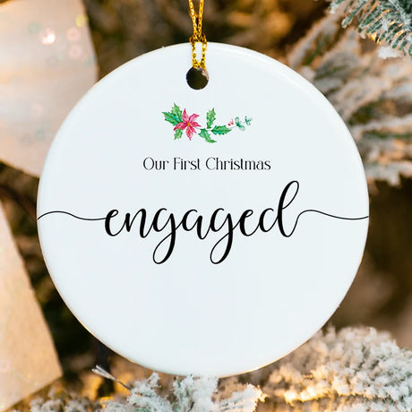 Our First Christmas Engaged Ornament – round ceramic engagement keepsake with gold ribbon