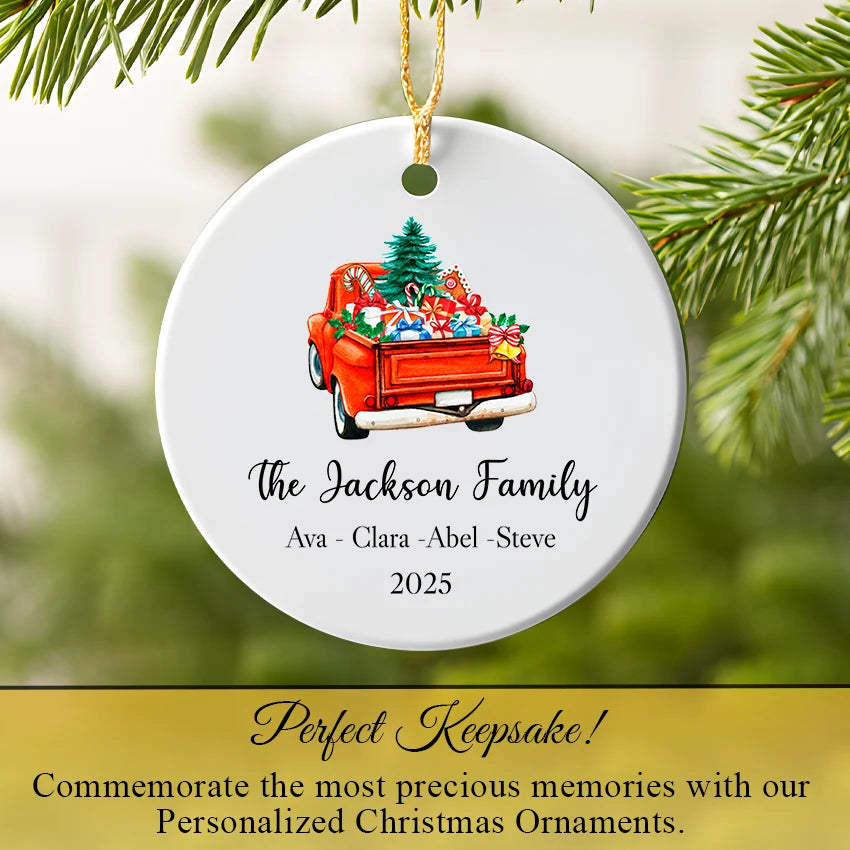 Personalized red truck ornament hanging on a Christmas tree branch