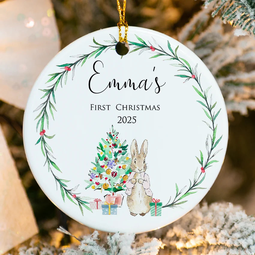 Side profile of the round ornament highlighting the delicate gold hanging ribbon
