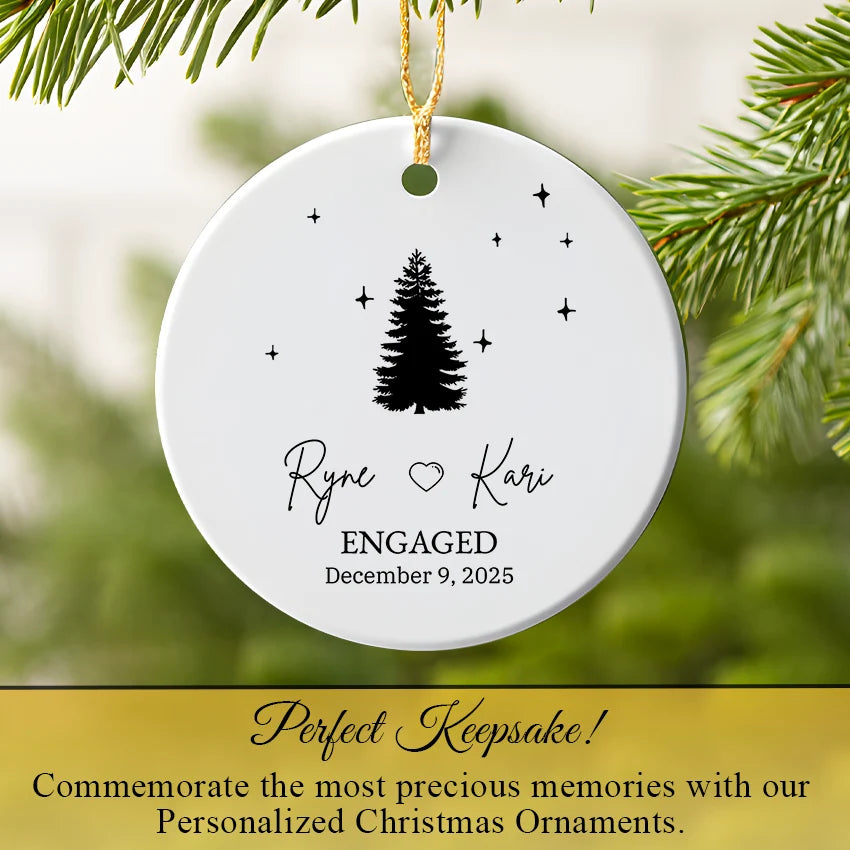 Engagement ornament hanging on a Christmas tree with warm fairy lights