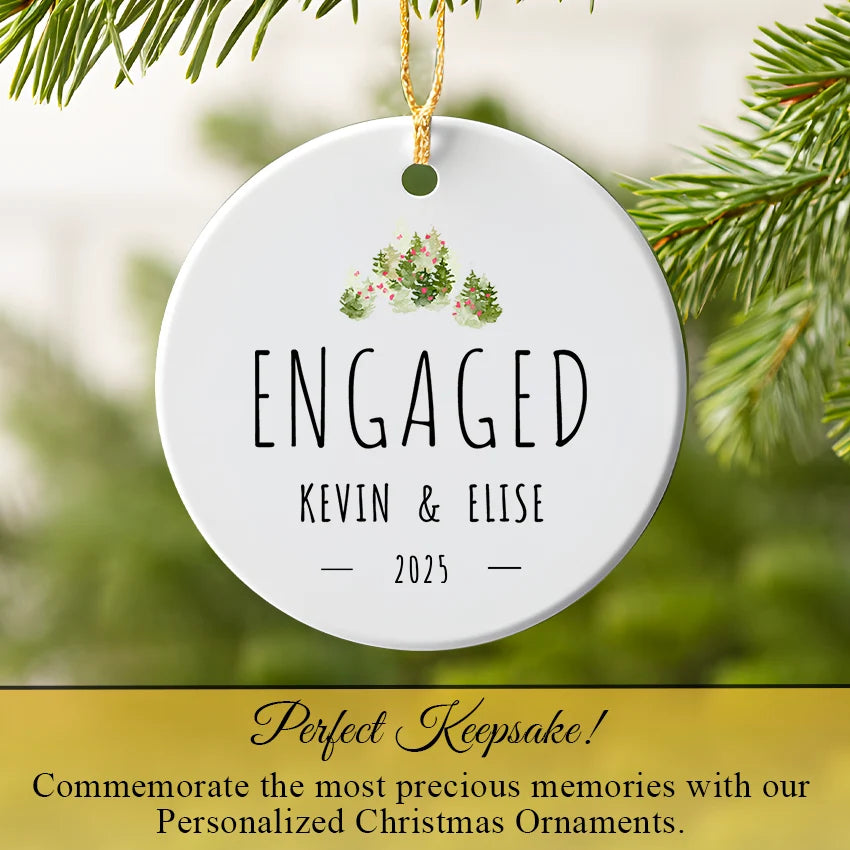 Engaged couple ornament hanging on Christmas tree with jungle leaf motif and gold ribbon