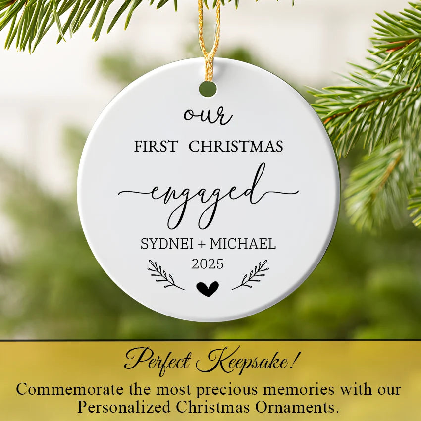 Our First Christmas engaged ornament hanging on a tree branch with twinkling lights