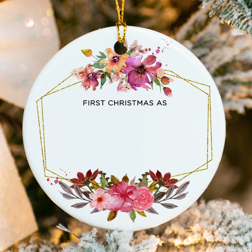 Close-up of floral details on glossy porcelain ornament showing personalized names and date"