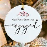 Close-up of ceramic engagement ornament showing glossy finish and cranberry wreath detail
