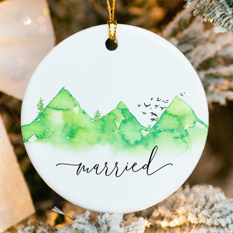 Close-up of glossy porcelain wedding ornament showing fused mountain design detail