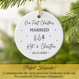 Newlywed ornament hanging from a pine branch, illuminated by warm Christmas lights