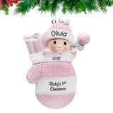 Baby girl in mitten ornaments for first Christmas, a delightful keepsake to celebrate her Christmas.