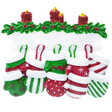 Close‑up of ten detailed resin mittens with hand‑lettered names