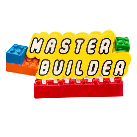 Close‑up of Master Builder Christmas ornament showing raised block letters and custom text