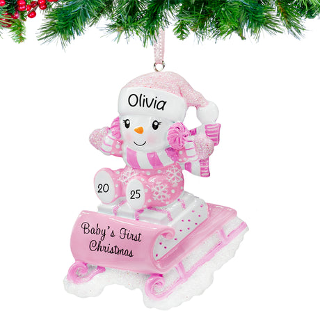 Baby's first Christmas ornaments featuring a snowbaby on a sled, a lovely gift for first Christmas.
