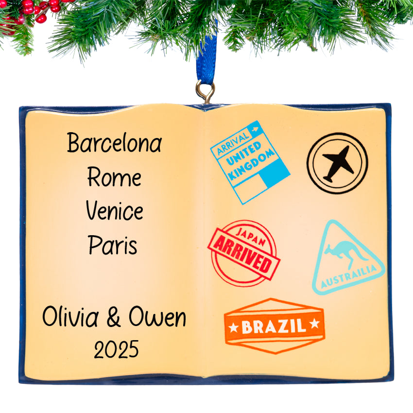 Ornament shaped like an open book with travel stamps and names on a white background