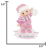 Personalized baby girl holding snowflake ornament, a unique keepsake to celebrate her special day.